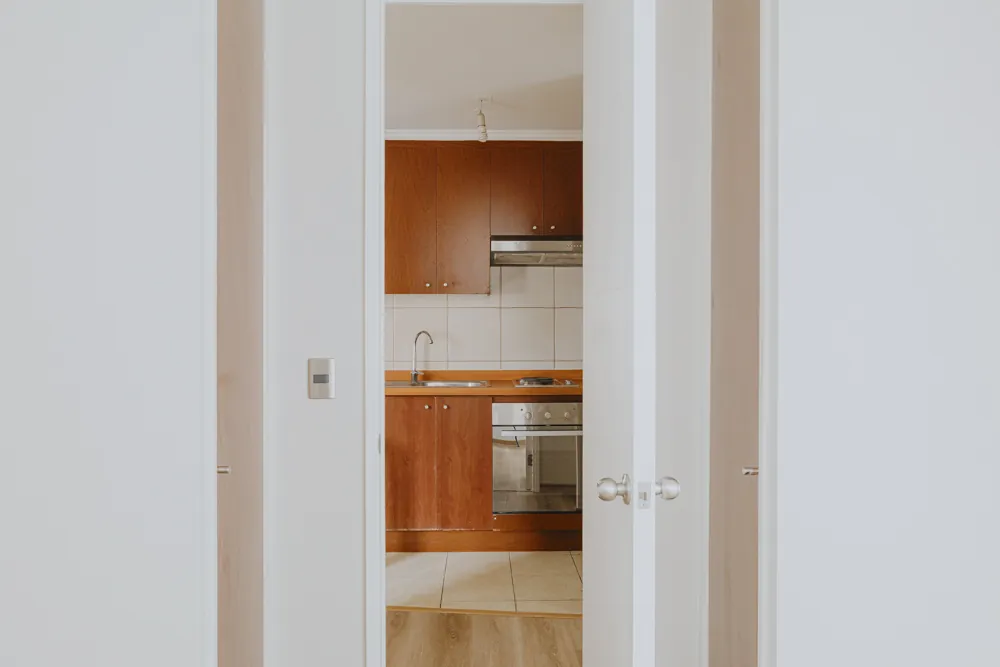 Puerta del dormitorio y cocina al fondo, departamento Av. Vicuña Mackenna 881